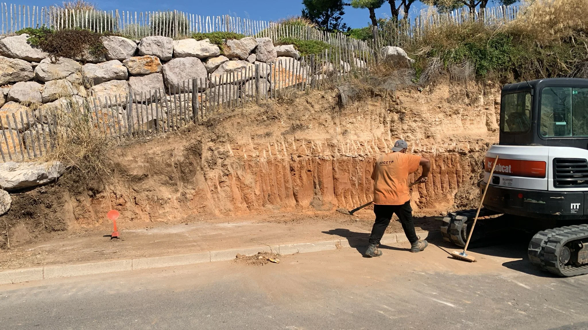 Réalisation d’un mur de soutènement pour un particulier à Mèze 02 Finition de la zone de pose du mur de soutènement par un équipier de SOCCTP